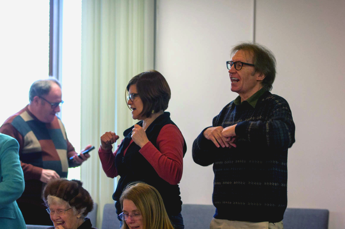 Goofing off during a Christmas sing-a-long, next to Pastor Wife #1.