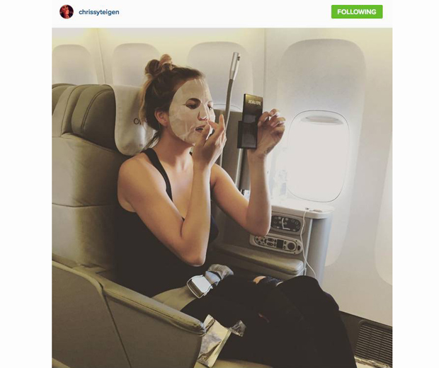 Chrissy Teigen travelling in style with her tissue sheet mask.