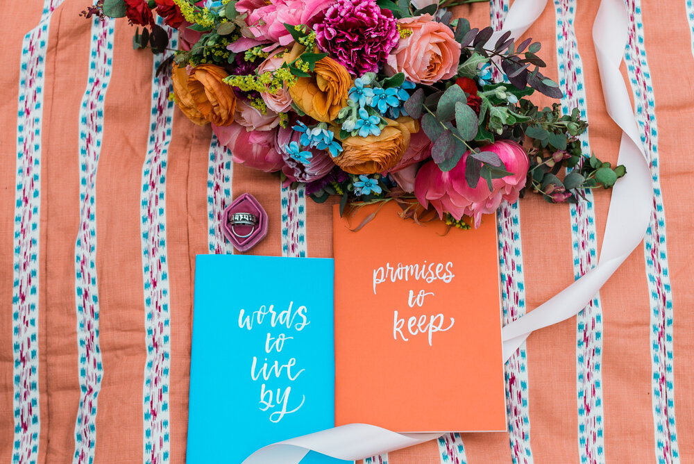 colorful wedding bouquet and wedding vow booklets (Copy)