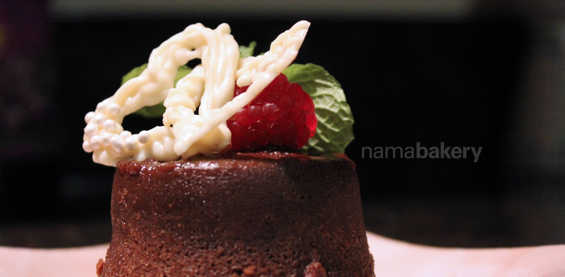 Chocolate lava cake, with interlocking white chocolate hearts. They are two separate hearts that are linked together and can swing freely when you pick them up.