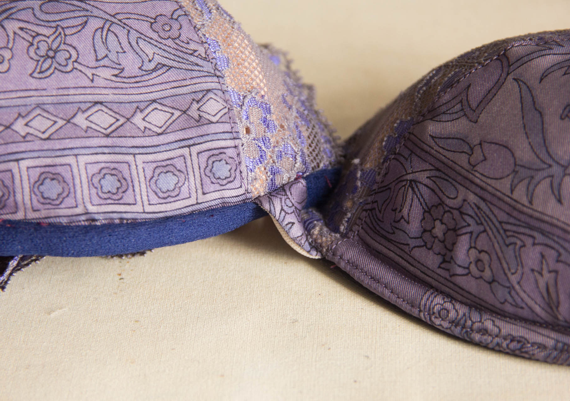 On the right, the cup topstitched with two rows of stitching, which holds the channelling under the cup. On the left, the channelling is attached but not yet topstitched.