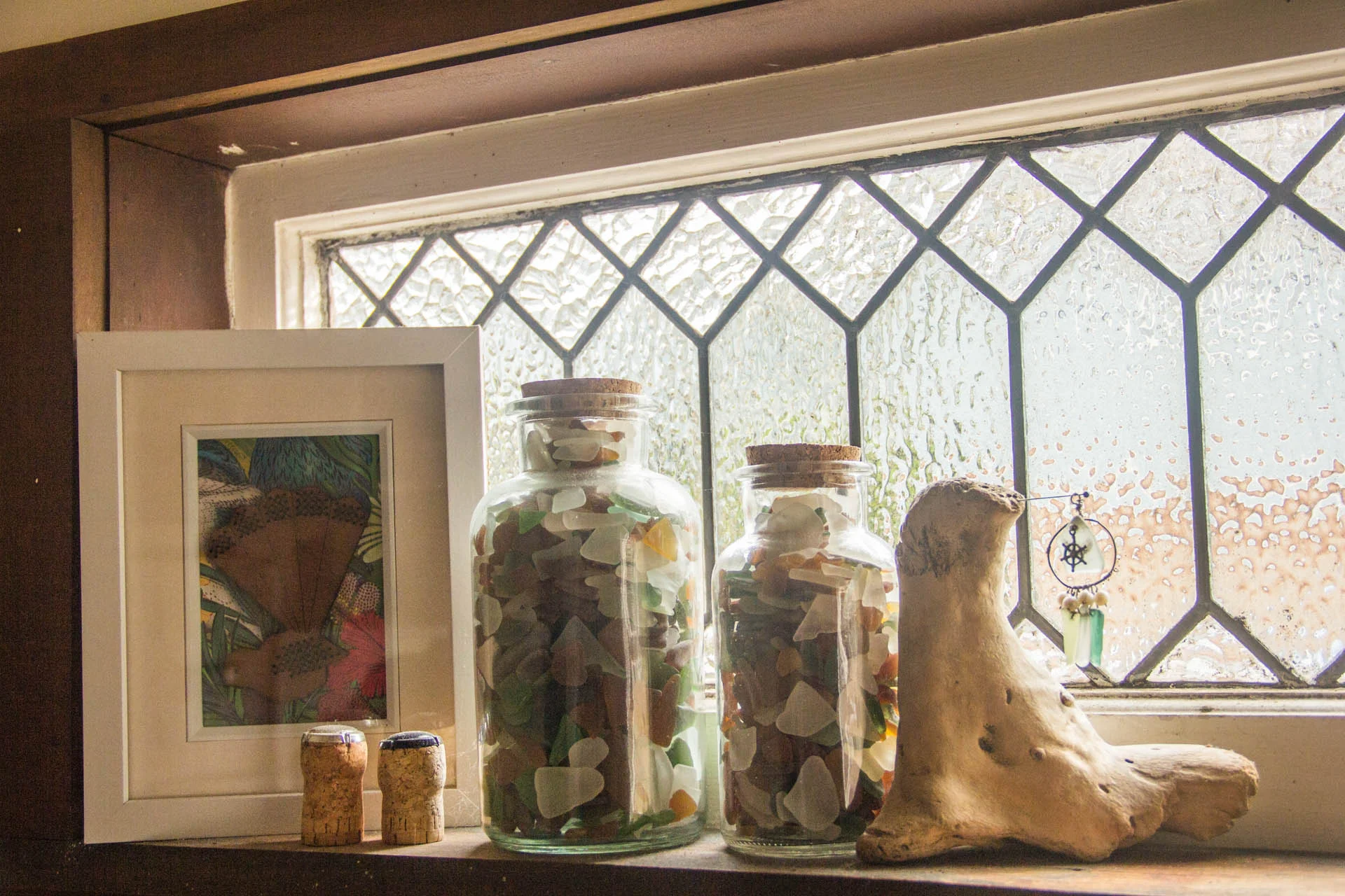 My little windowsill has a collection of sea glass Jon and I have found on beaches in our travels - plus a little charm I made for a necklace but can't wear, and the champagne corks from our engagement, and from Christmas last year.