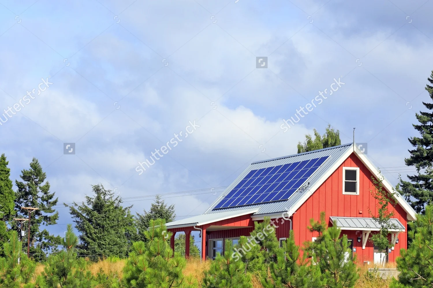 stock-photo-bright-red-building-with-solar-panels-on-the-metal-rooftop-on-a-mostly-sunny-summer-day-in-a-public-82509637.jpg