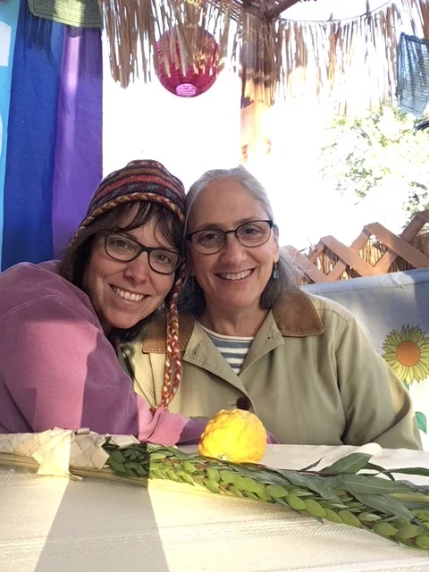Amy and her wife Liddy in their Sukkah
