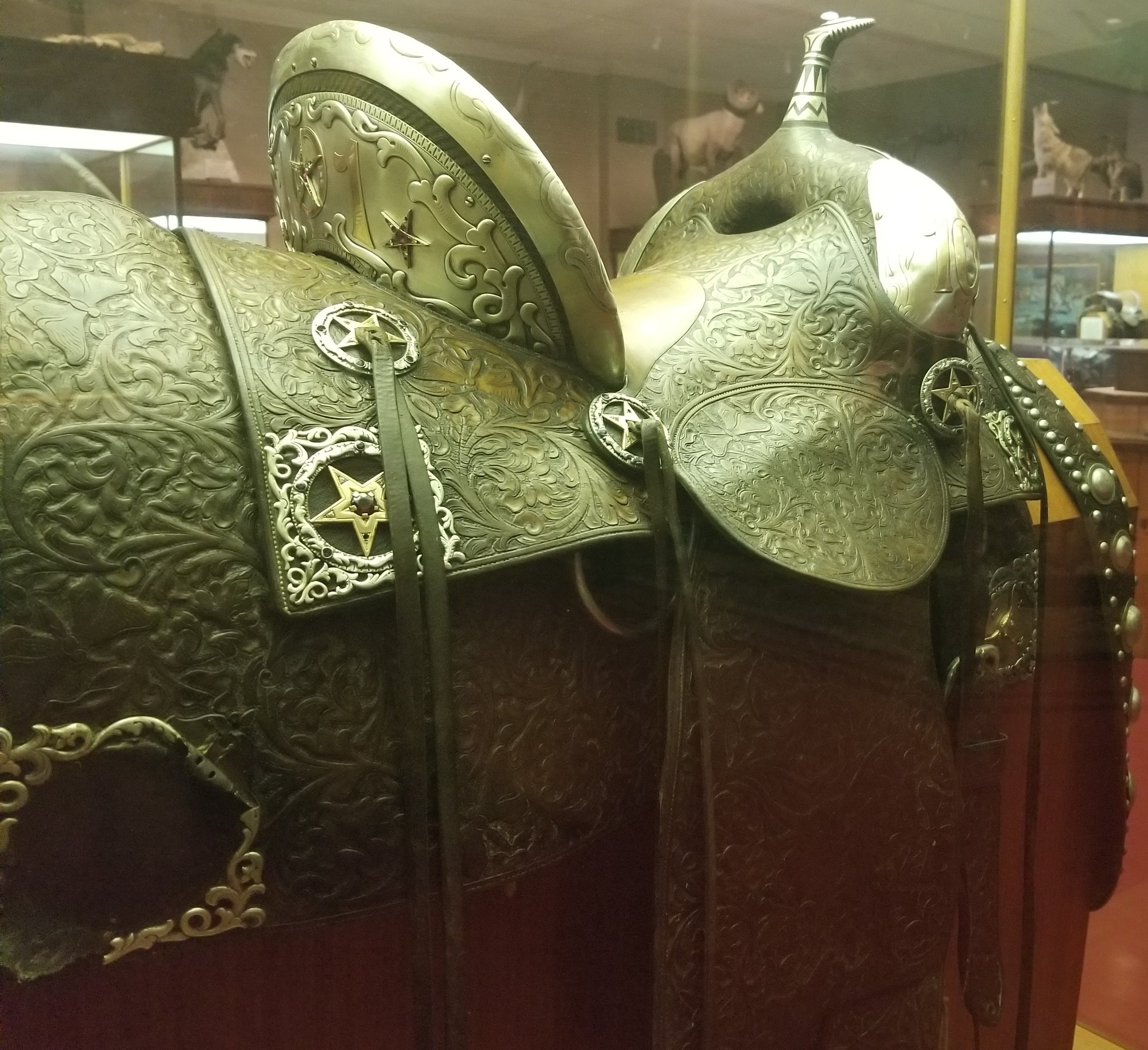 This is the 101 Ranch Show Saddle. "It was billed as “The World's Finest Saddle” when it made its appearance in the 101 Ranch Wild West Show... When new, the saddle contained one hundred and sixty-six diamonds, one hundred and twenty sapphires, seventeen rubies, four garnets, and fifteen pounds of gold and silver."