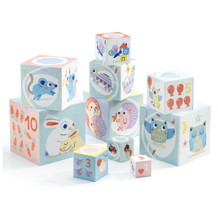 Stack of pastel-colored children's blocks decorated with cute animal and nature illustrations, including rabbits, owls, turtles, bees, and moons.