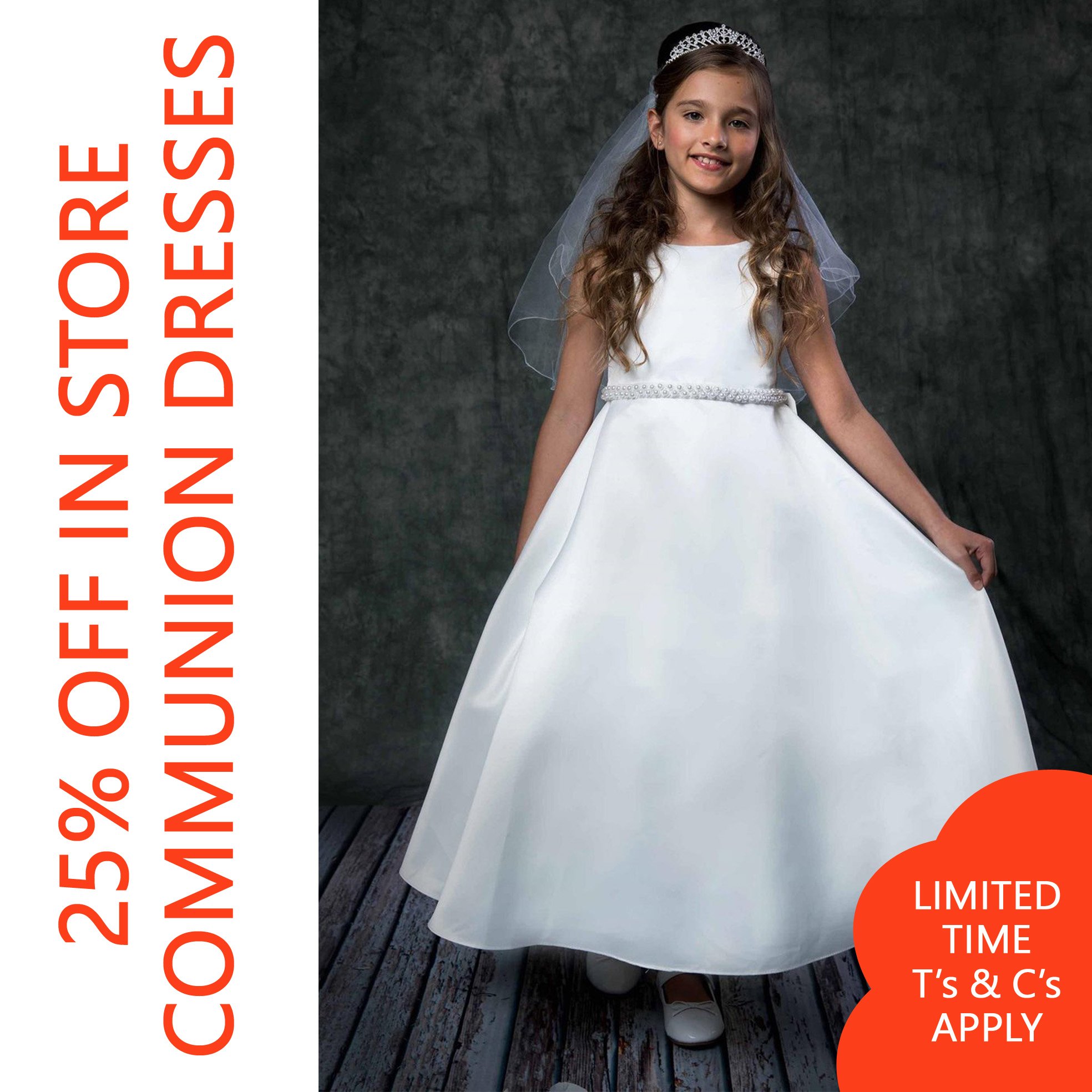 A young girl is dressed in a white dress with a tiara on her head and a veil, standing on a wooden deck.