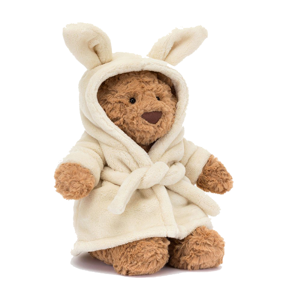 A plush teddy bear dressed in a white bathrobe with a hood that has bunny ears.