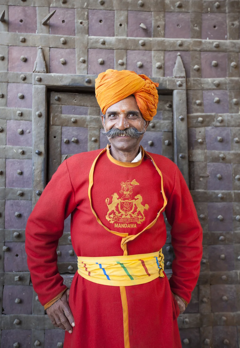Hotel Worker in Red Robe and Wearing Orange Turban