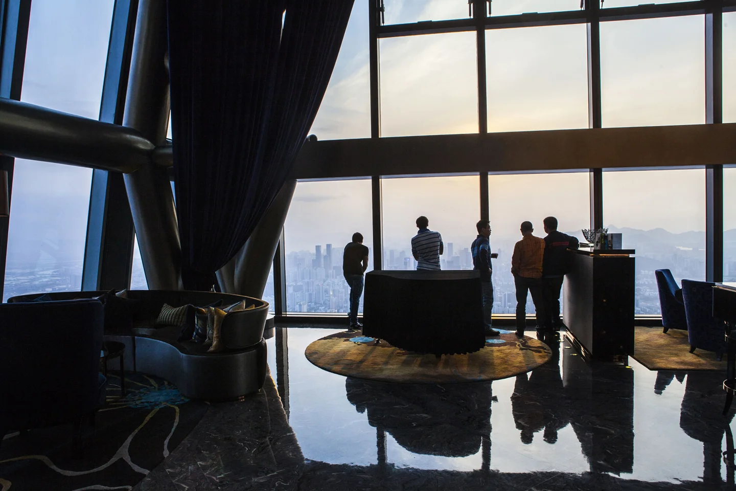 Room with Large Windows and Figures Conversing