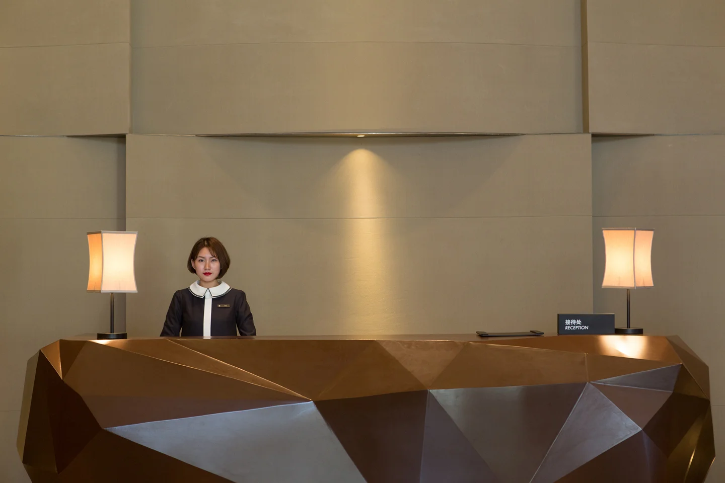 Woman Standing Behind Front Desk