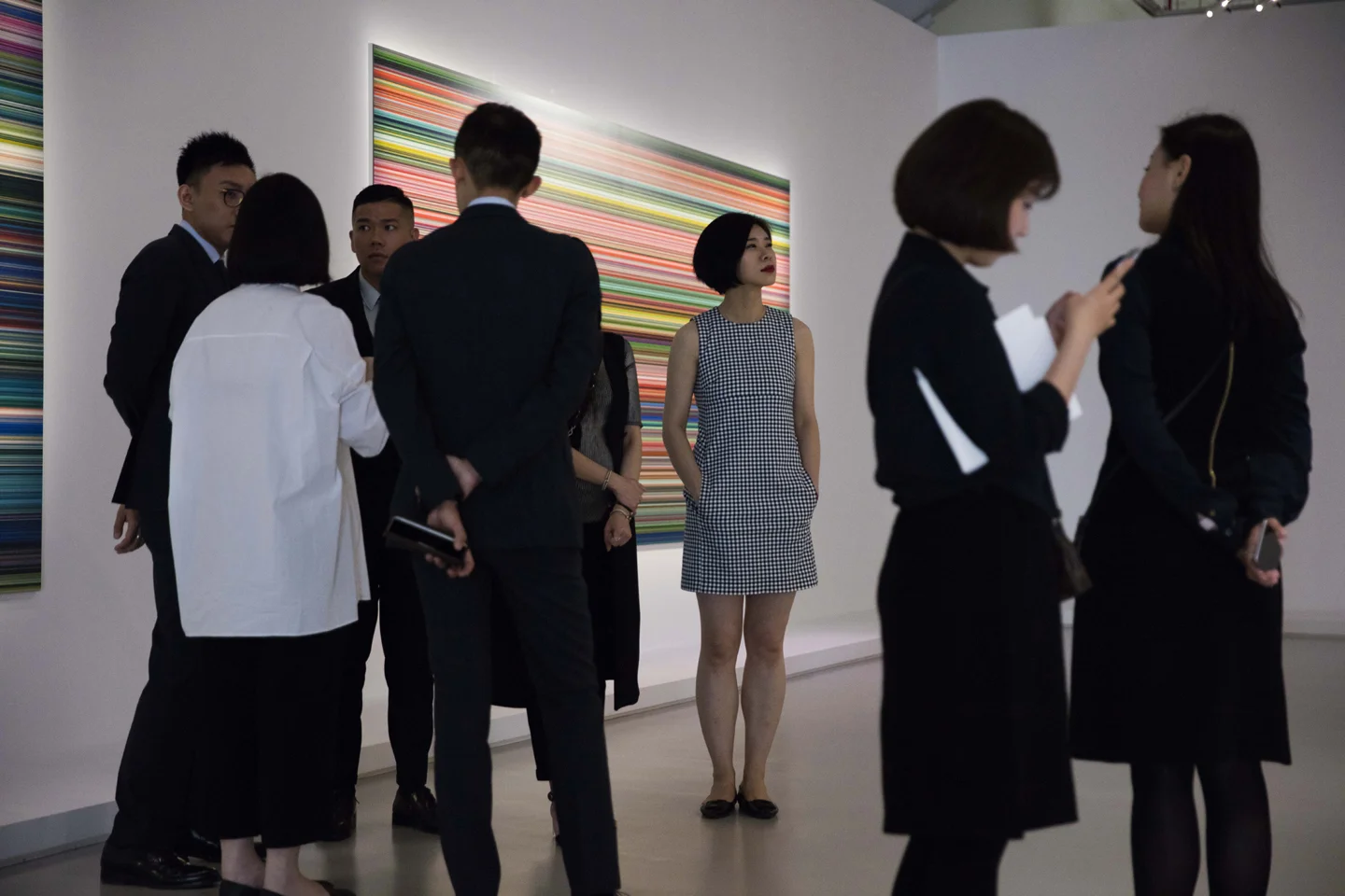 Group of people standing in art gallery