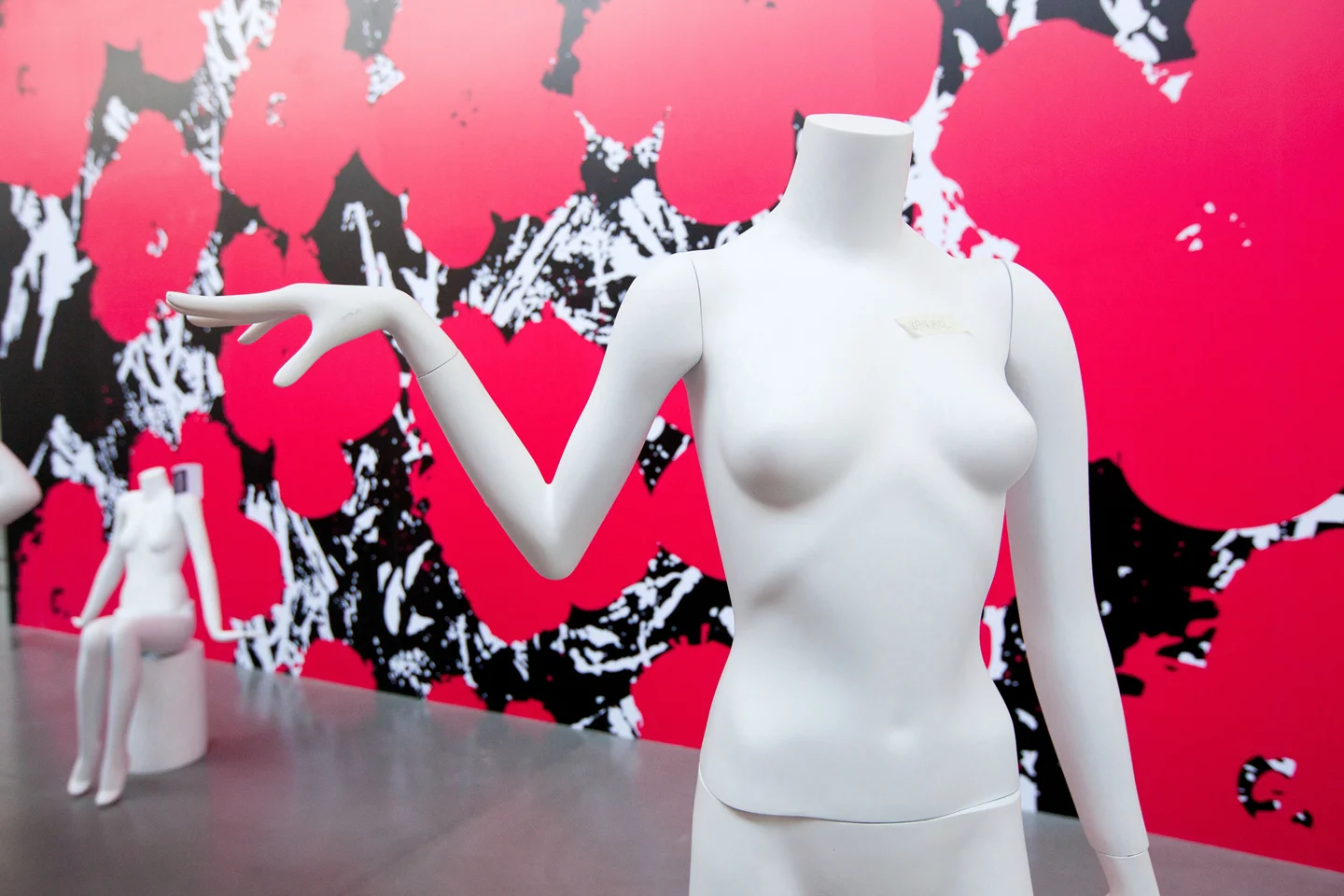 Headless mannequins in front of modern graffiti style background
