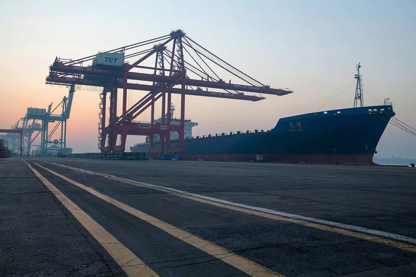 Large freight ship docked at port waiting for loading