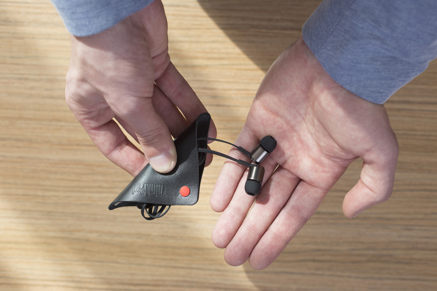 Man Holding Earbuds in Hands