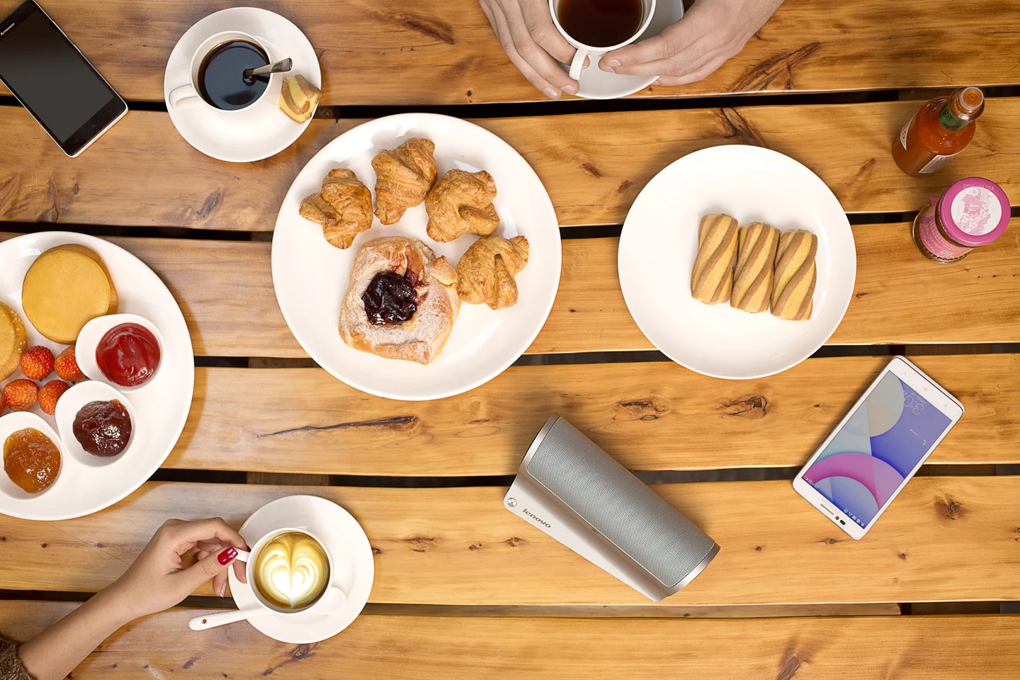 assorted food and coffee on wooden picnic table