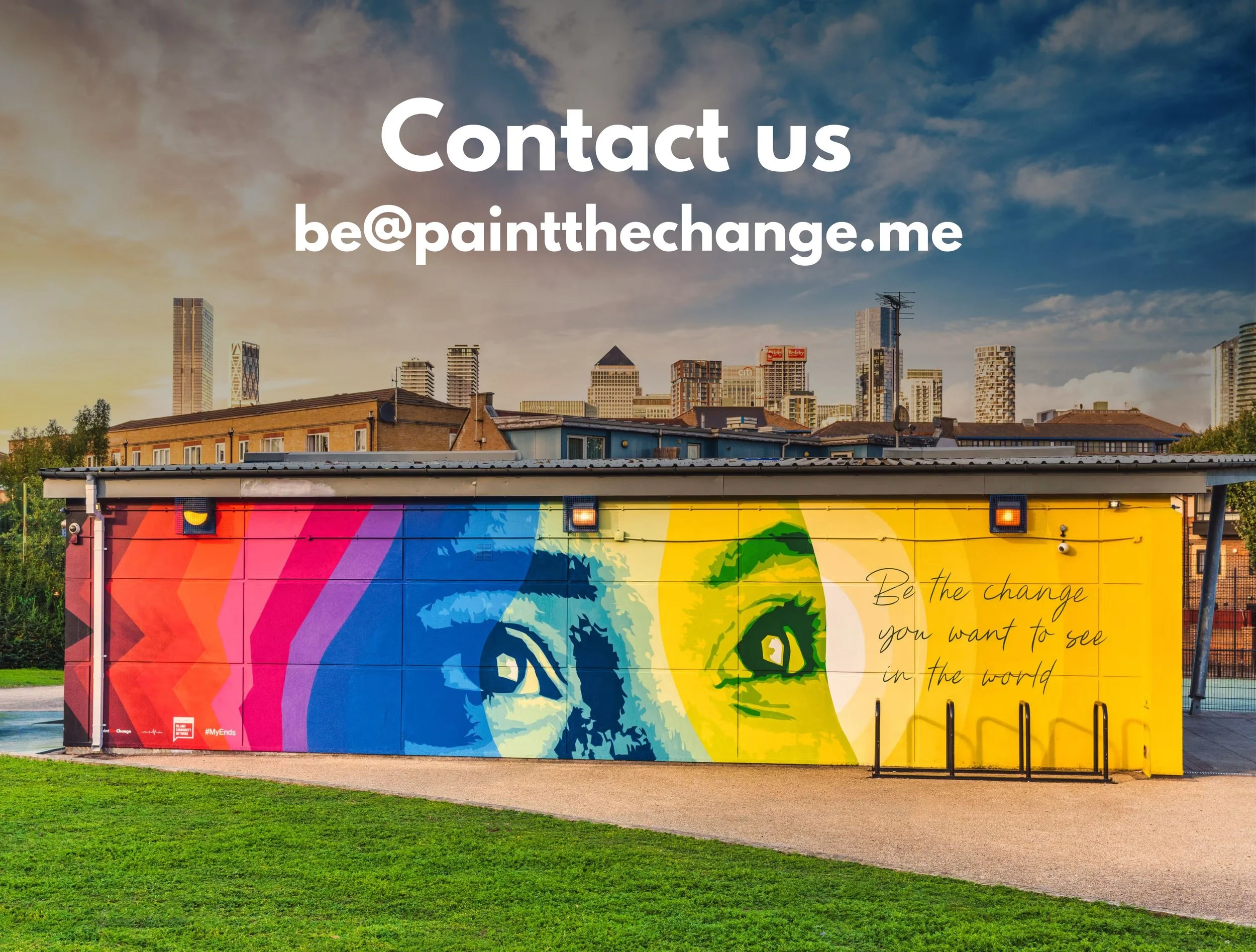 A picture a mural which has the face of a women on it. There is text on the right side that says "Be the change you want to see in the world"