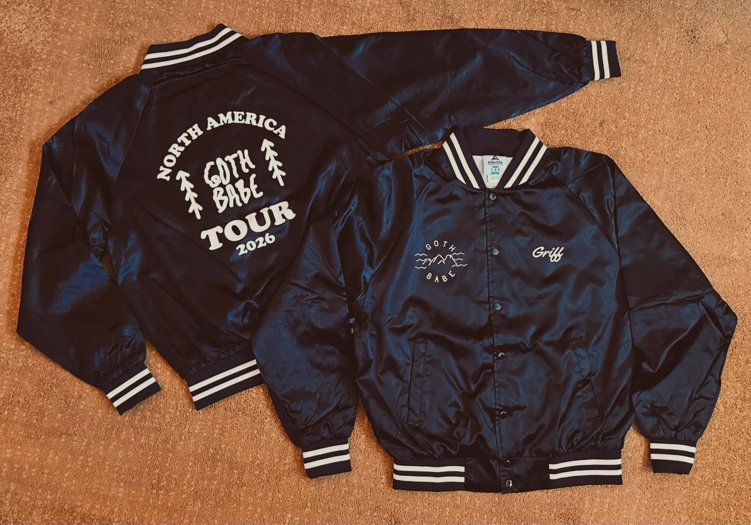 Black baseball jackets with white ink.