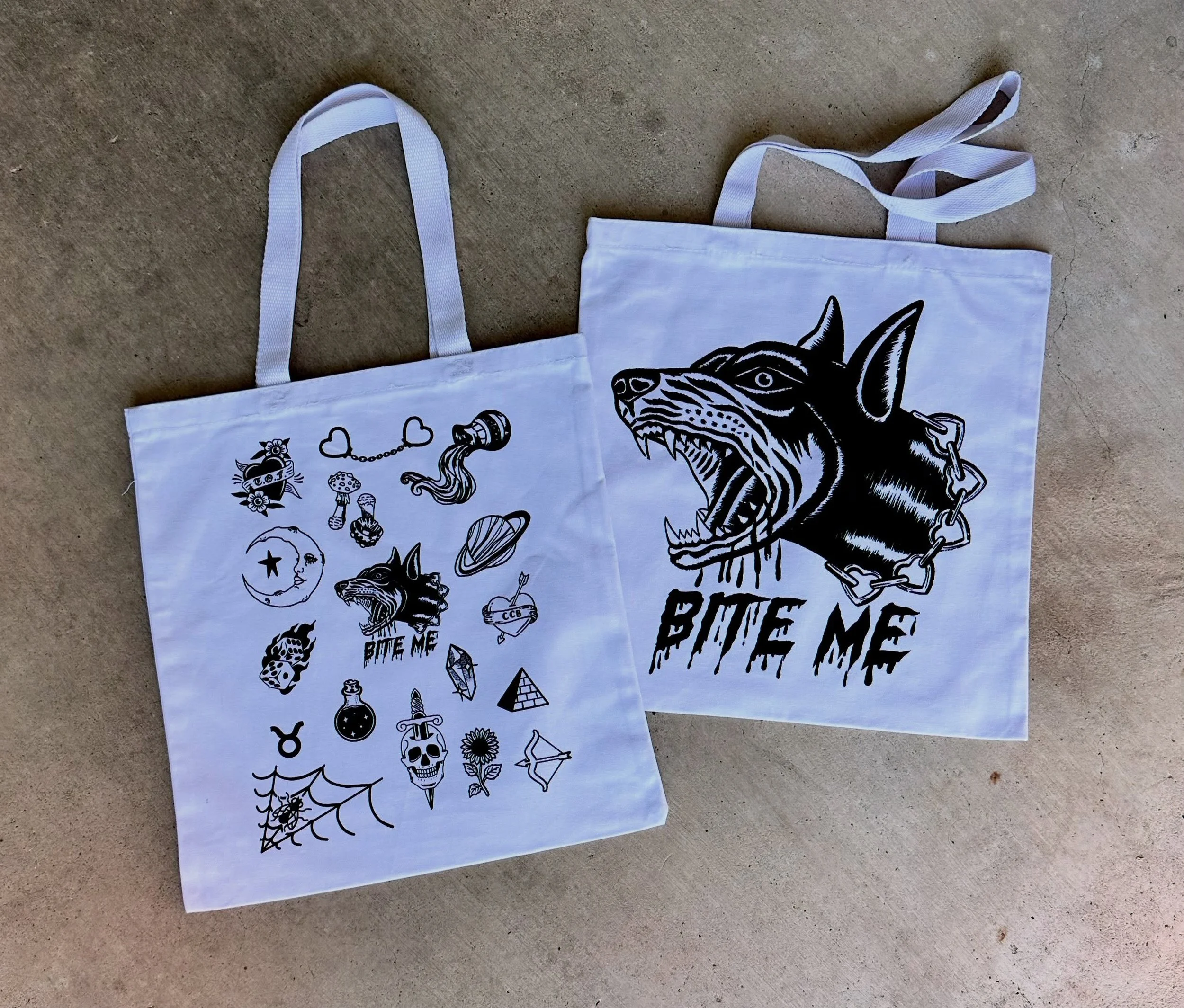 Black ink screen printed on white totes.