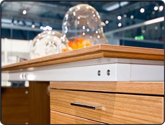 Lightweight papers are used on the edges and drawer fronts of theis commercial desk. The TFL on the top carries a matching pattern. Photo: Material Intelligence