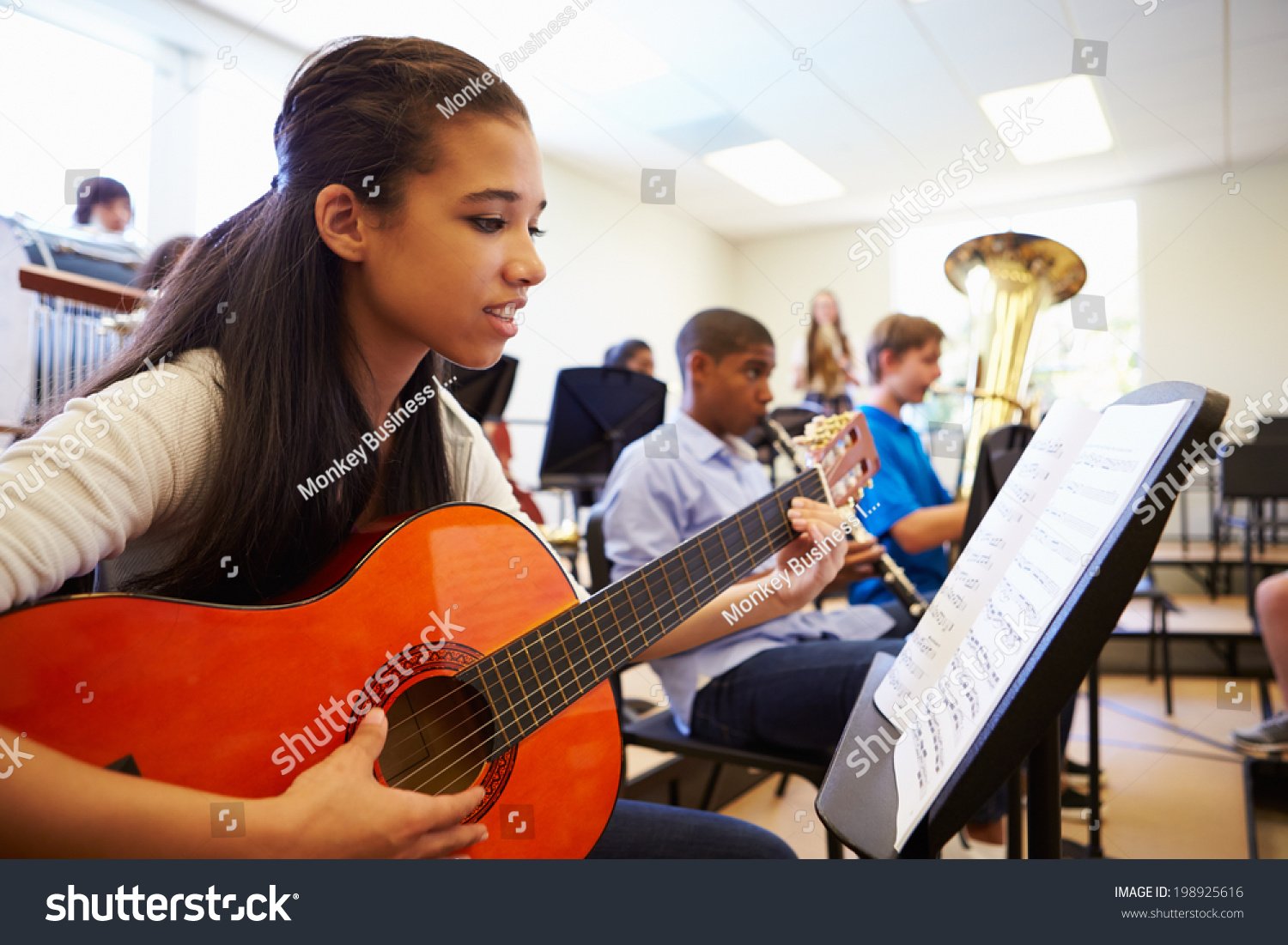 Art Theatre Music possible stock-photo-female-pupil-playing-guitar-in-high-school-orchestra-198925616.jpg