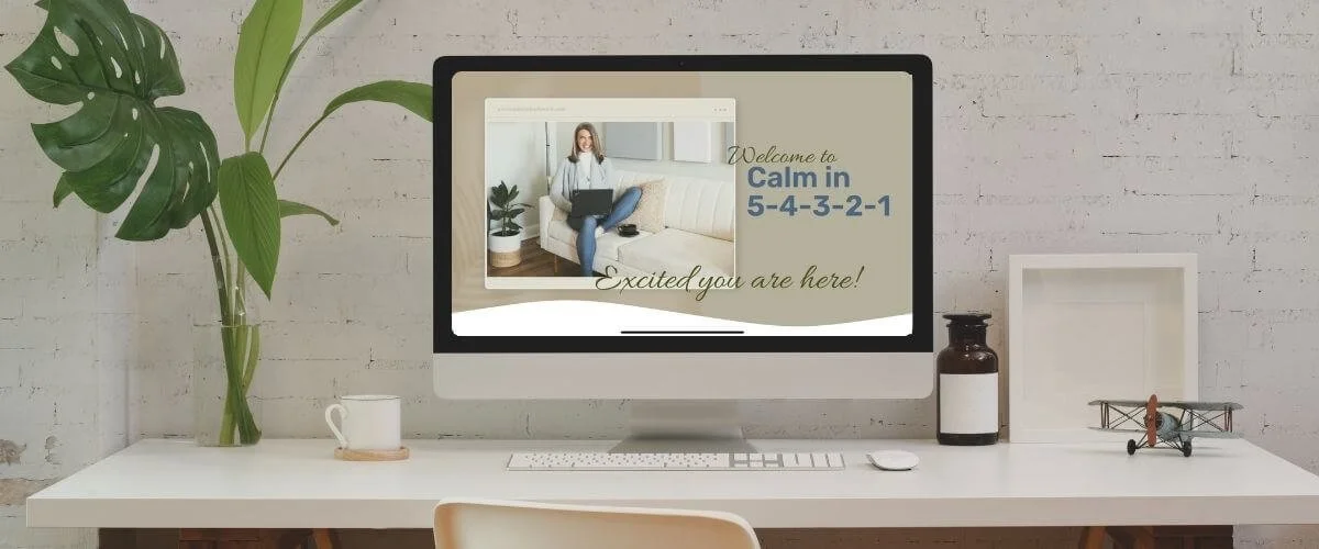 Calm in 5-4-3-2-1 nervous system regulation course on computer in minimalist workspace with plant and neutral tones