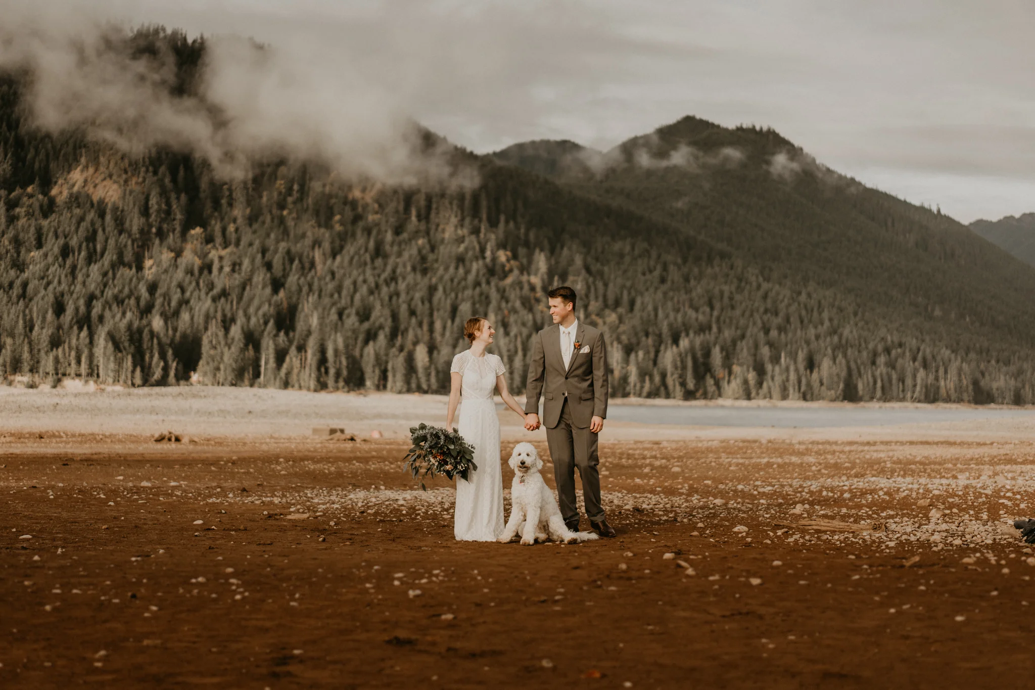 Bride and groom with their dog at Lake Cushman by Olympic National Park for their elopement