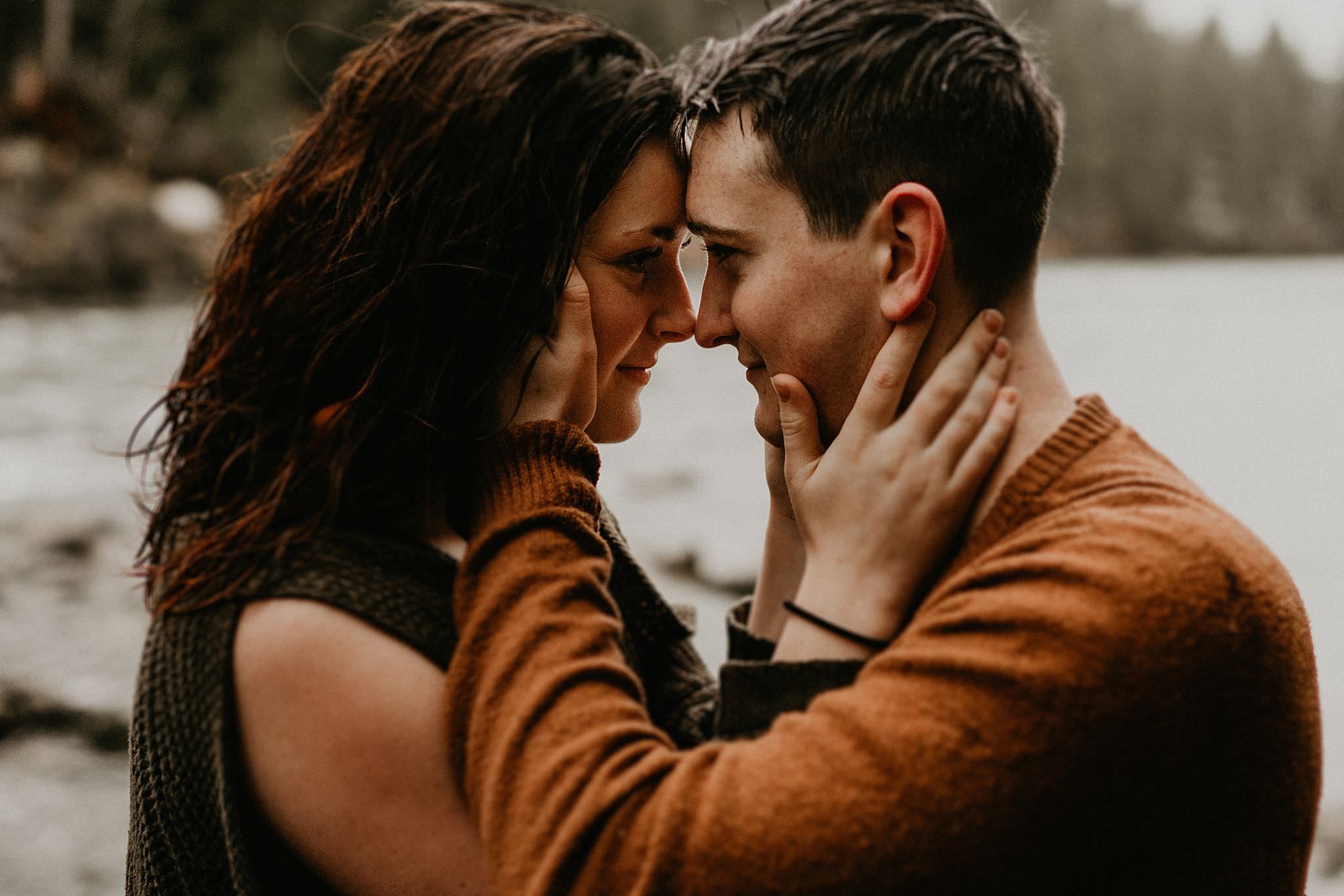 Couple kissing by the river in Snoqualmie
