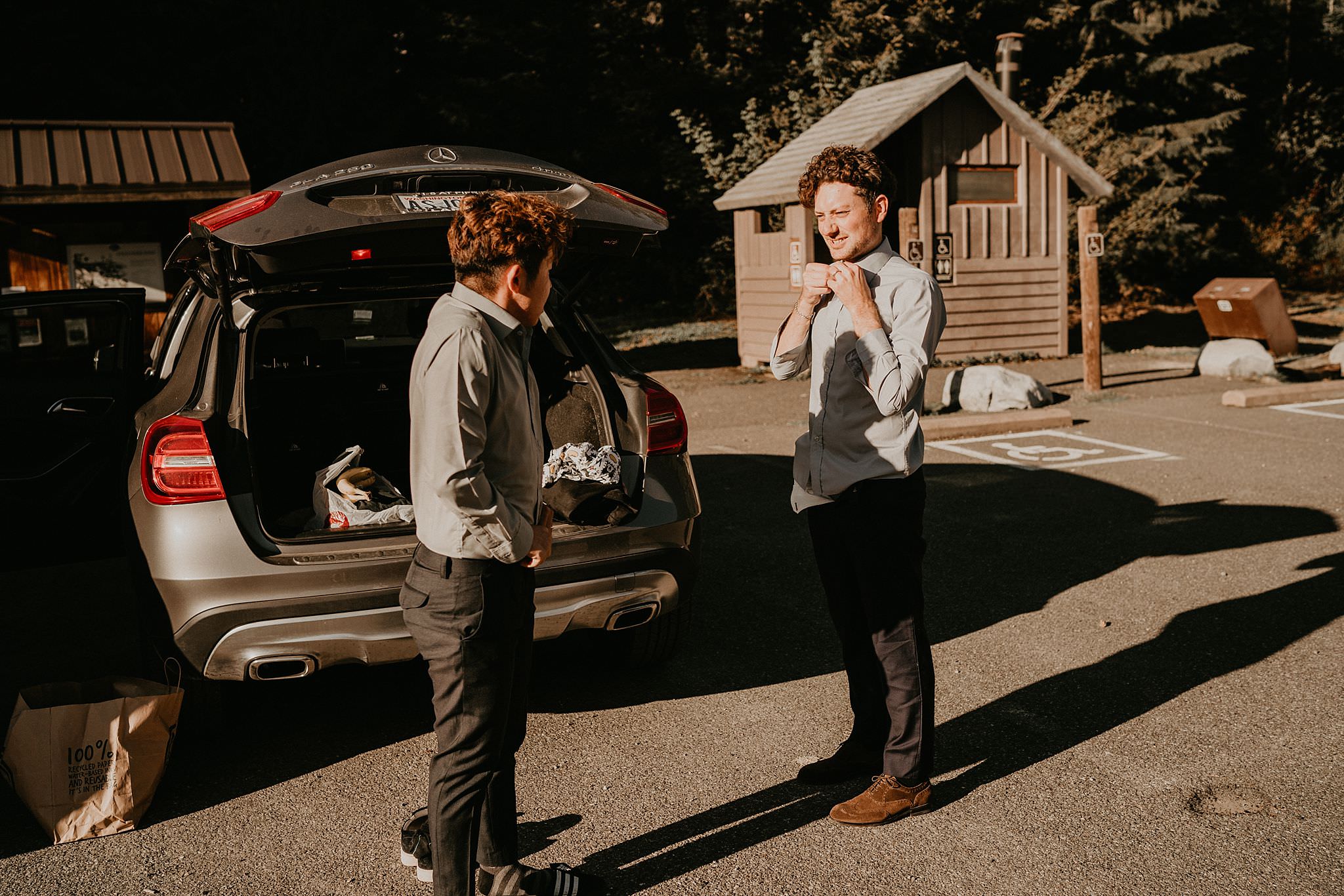 Gay couple getting ready for elopement at Gold Creek Pond in Washington