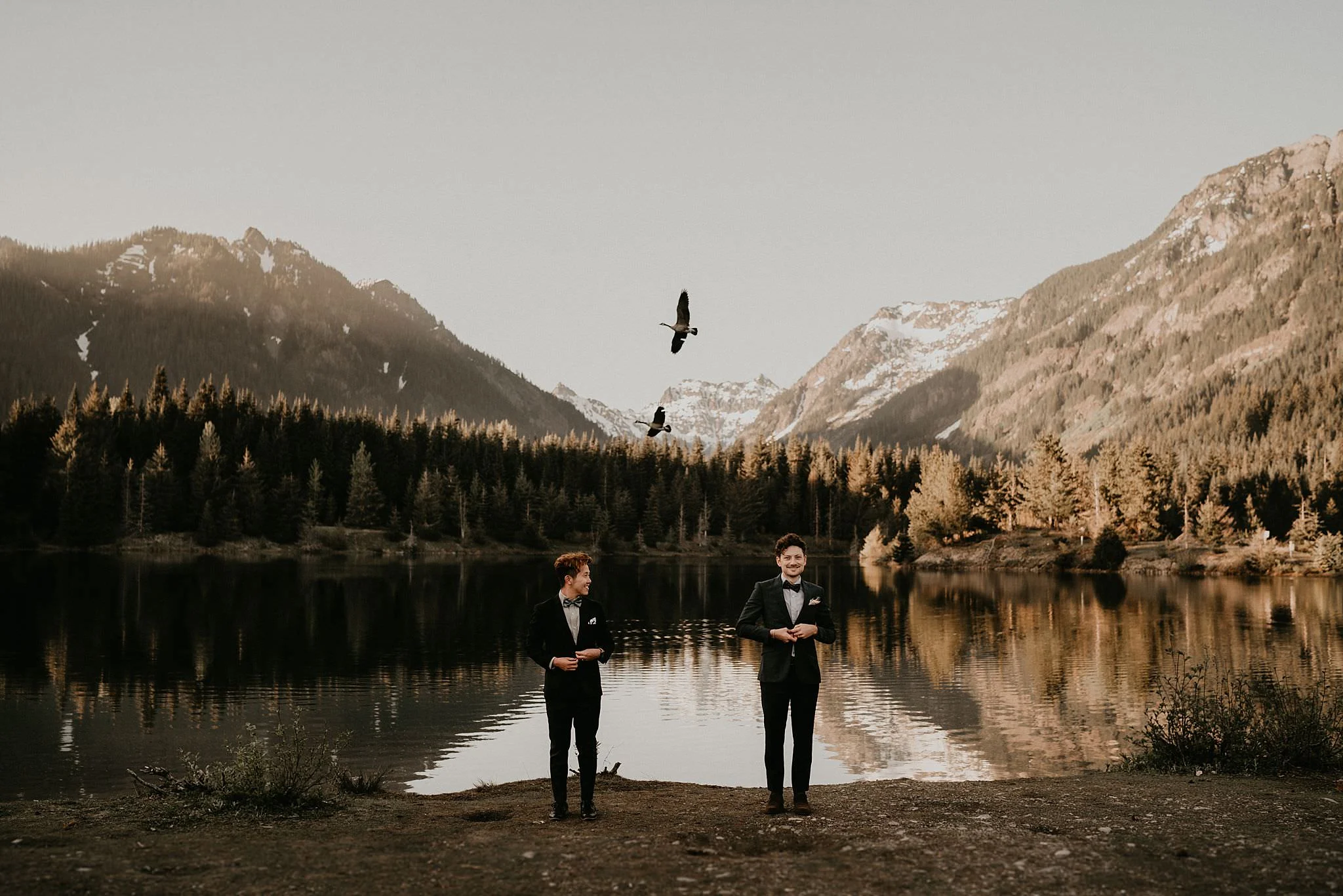 Gay couple married in front of an alpine lake in the mountains outside of Seattle Washington