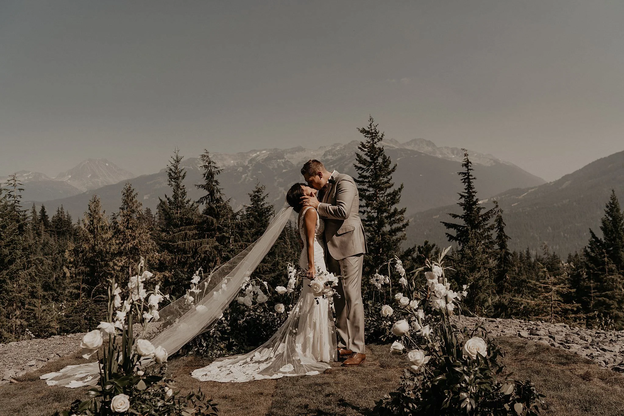 Epic first kiss captured by the best Whistler Helicopter Wedding Photographer