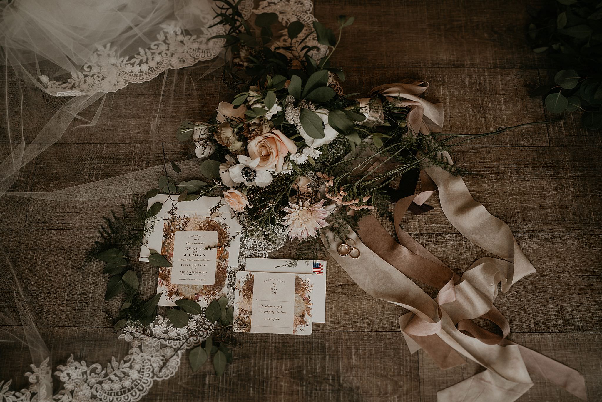 Flat lay detail photos of blush invitations