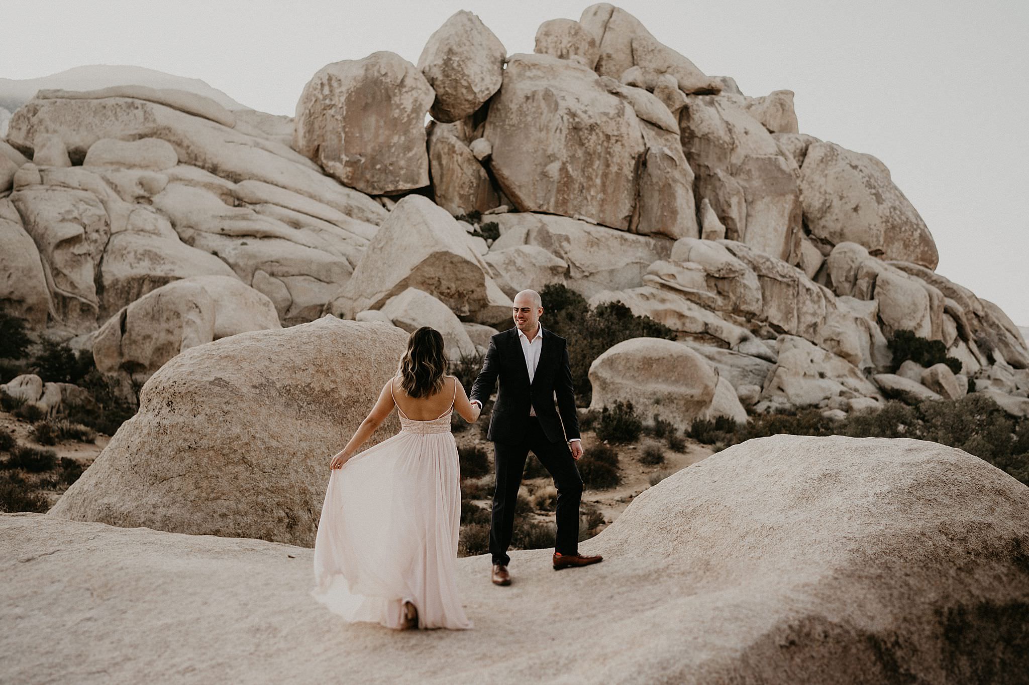 Couple looking majestic under the sun for their elopement wedding day at Joshua Tree National Park