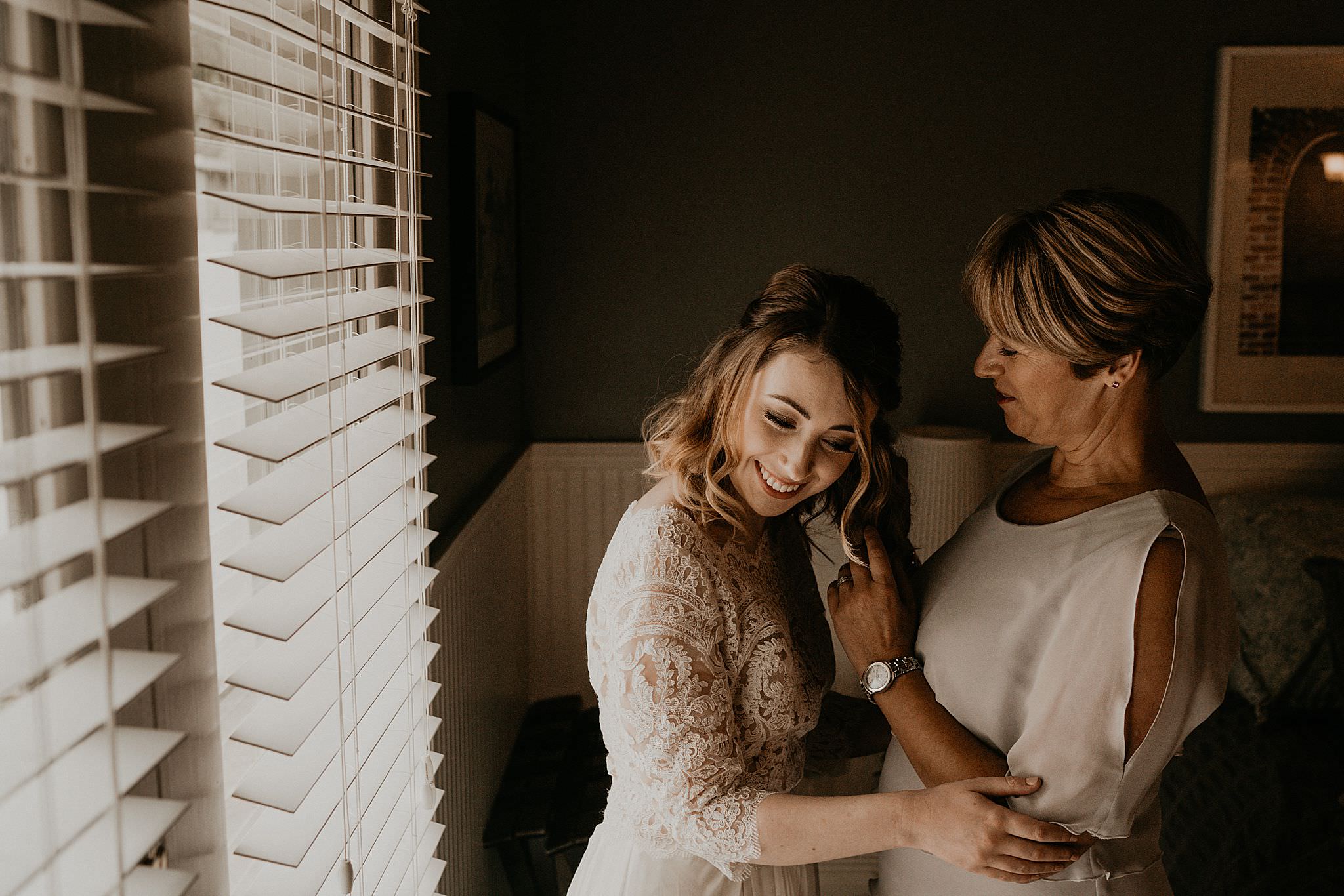 Bride getting ready in her boho wedding dress for her intimate wedding at Ebey's landing on Whidbey island