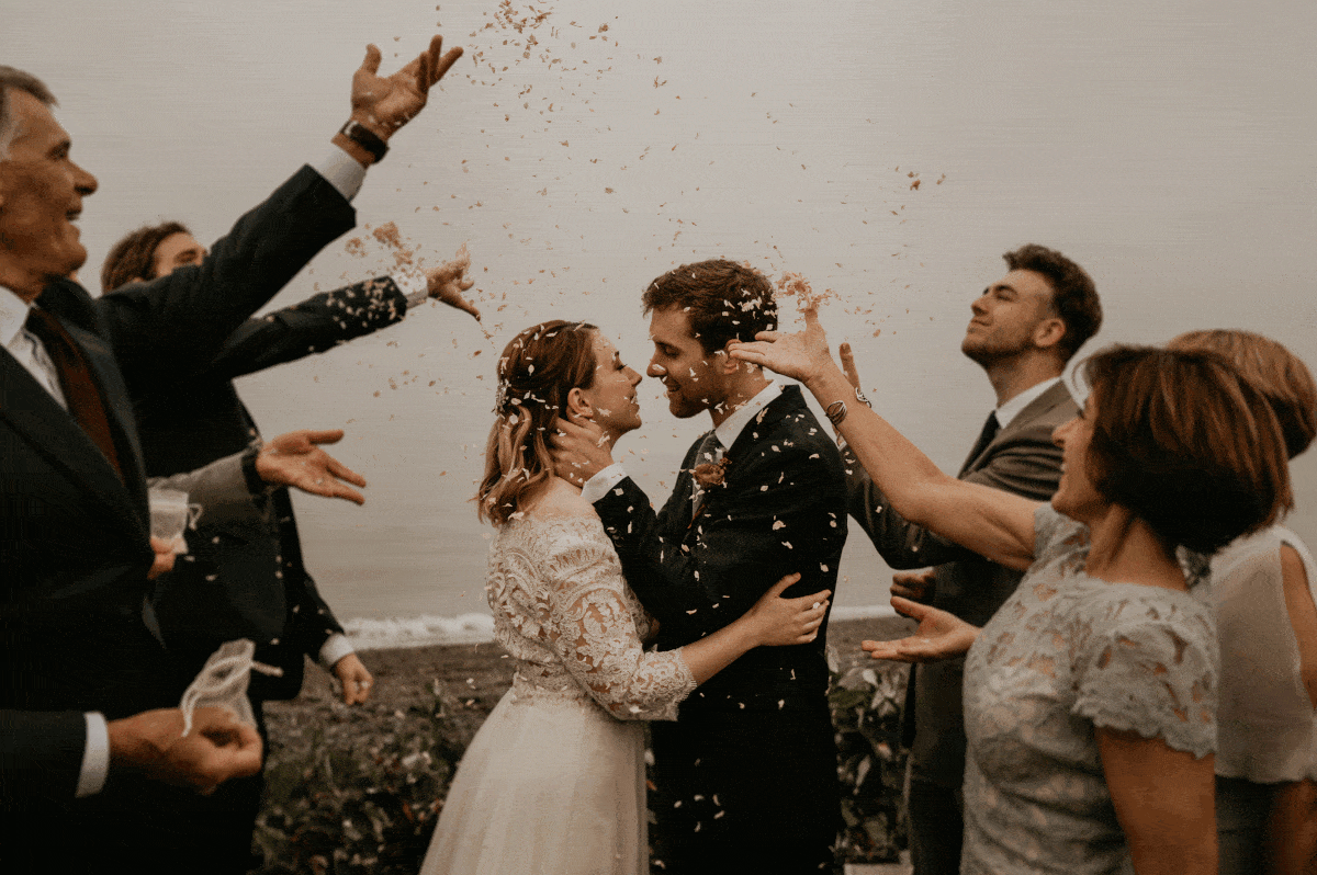 Couple kissing on Whidbey island with family for their intimate wedding elopement