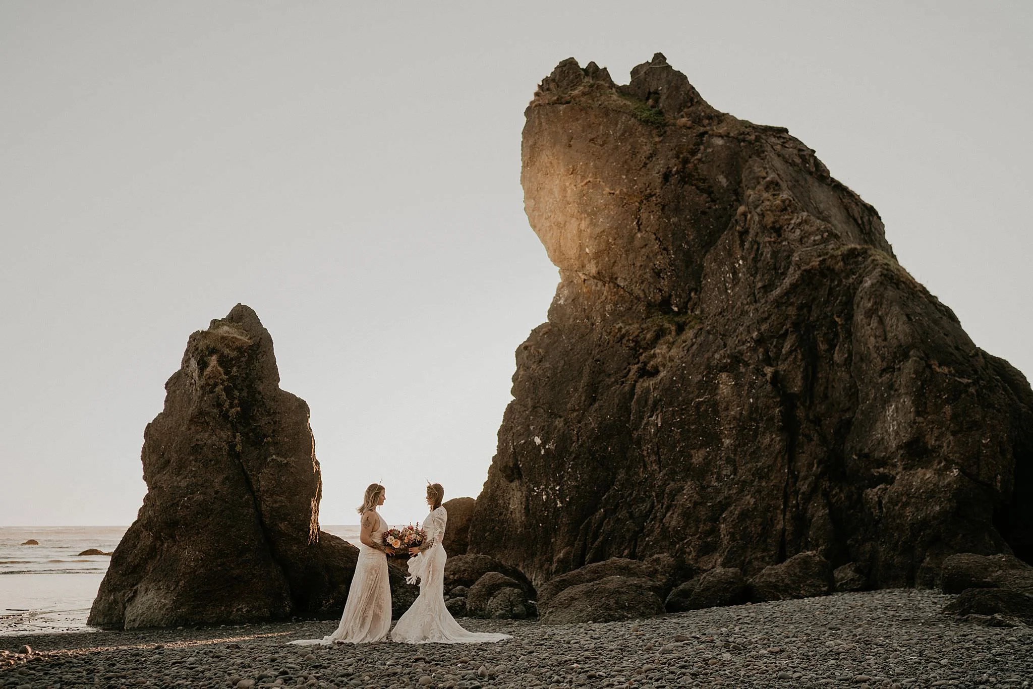 Lesbian brides at Ruby Beach elopement wearing bohemian Rue de seine dress from Seattle Dress Theory