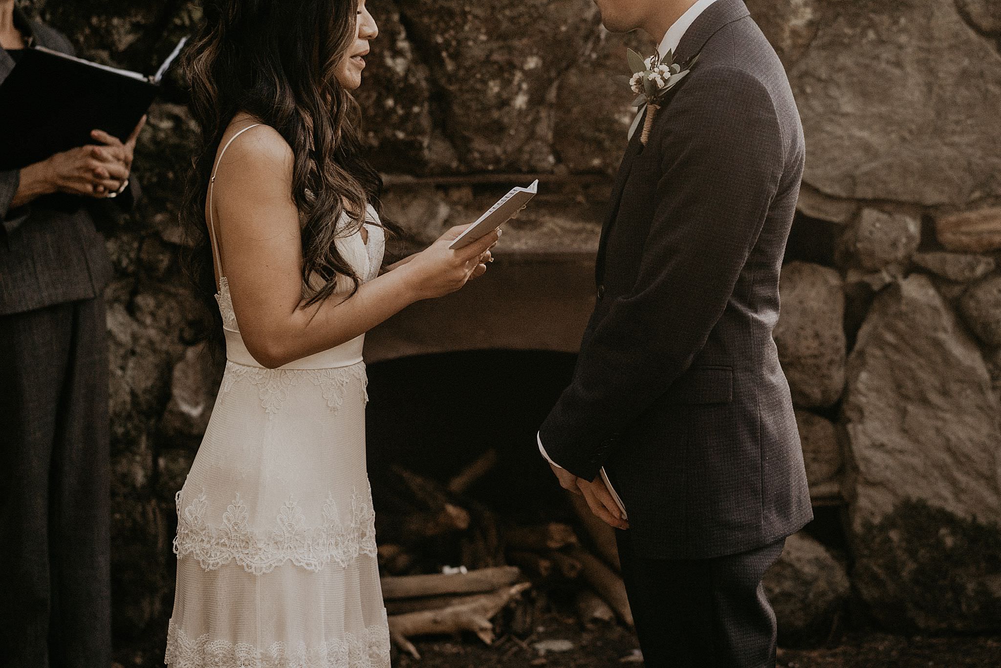 Bride reading her vows at the intimate wedding near columbia river gorge, skamania stone house
