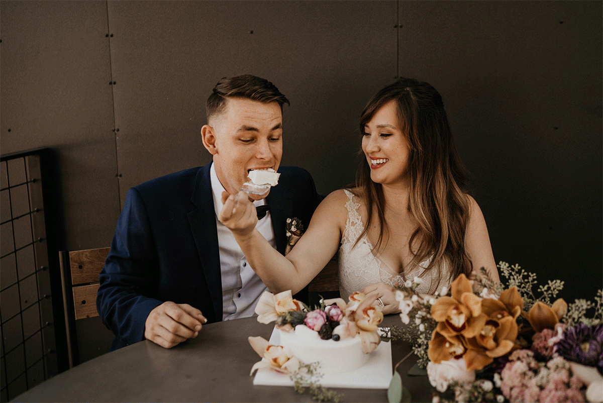 Bride and groom eating their wedding cake at Autocamp yosemite