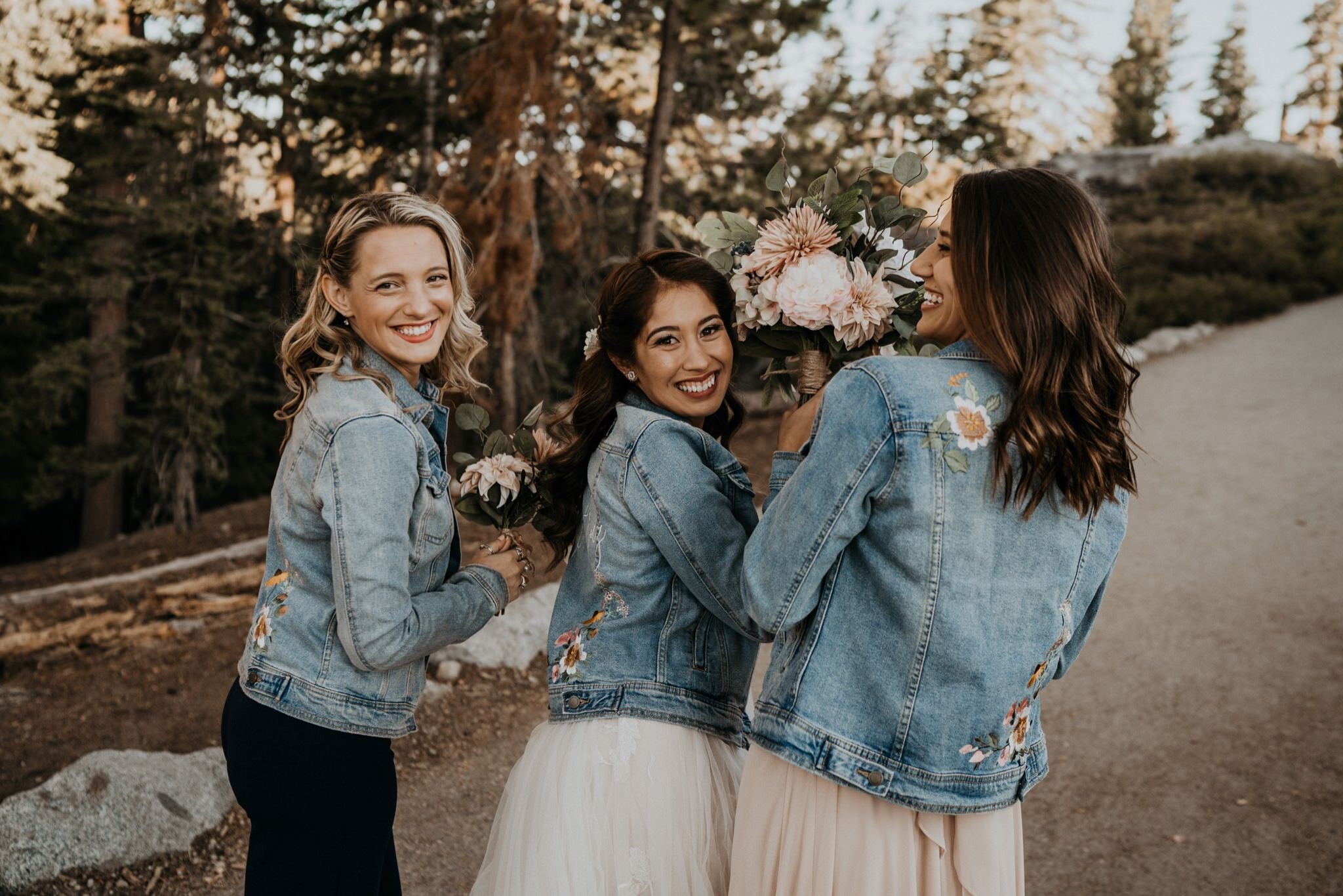 Matching denim jackets bride and bridesmaid Dearly Threaded | Yosemite National Park elopement and wedding photos at Glacier Point during sunrise with view of Half Dome