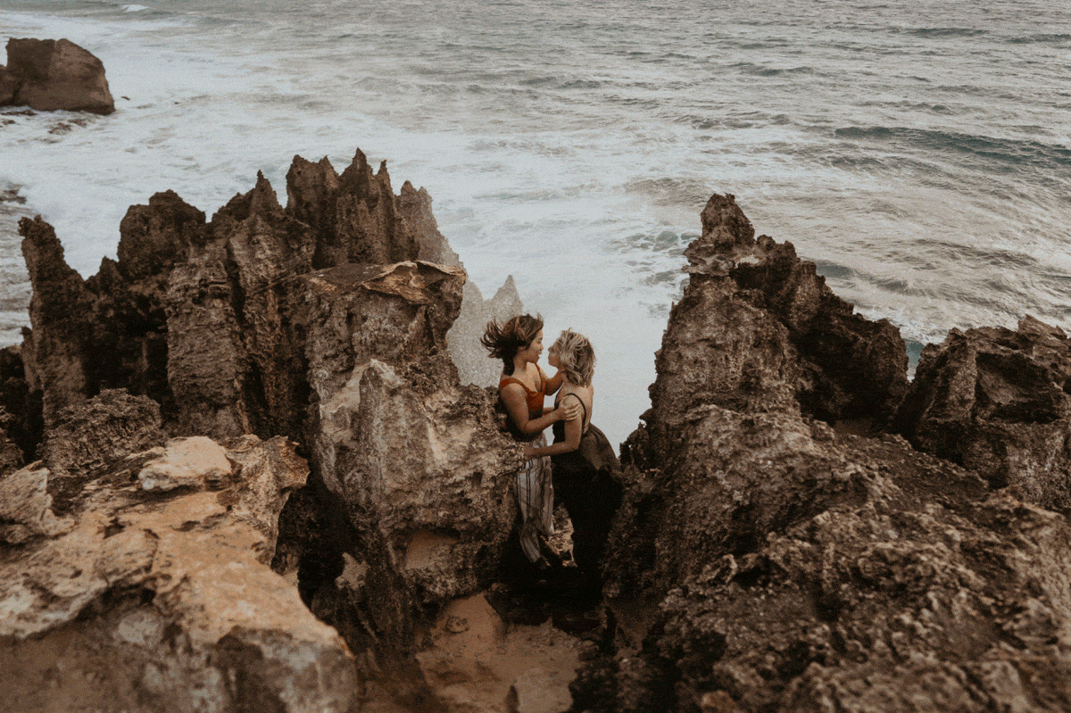 Lesbian couple kissing for their engagement photos in kauai