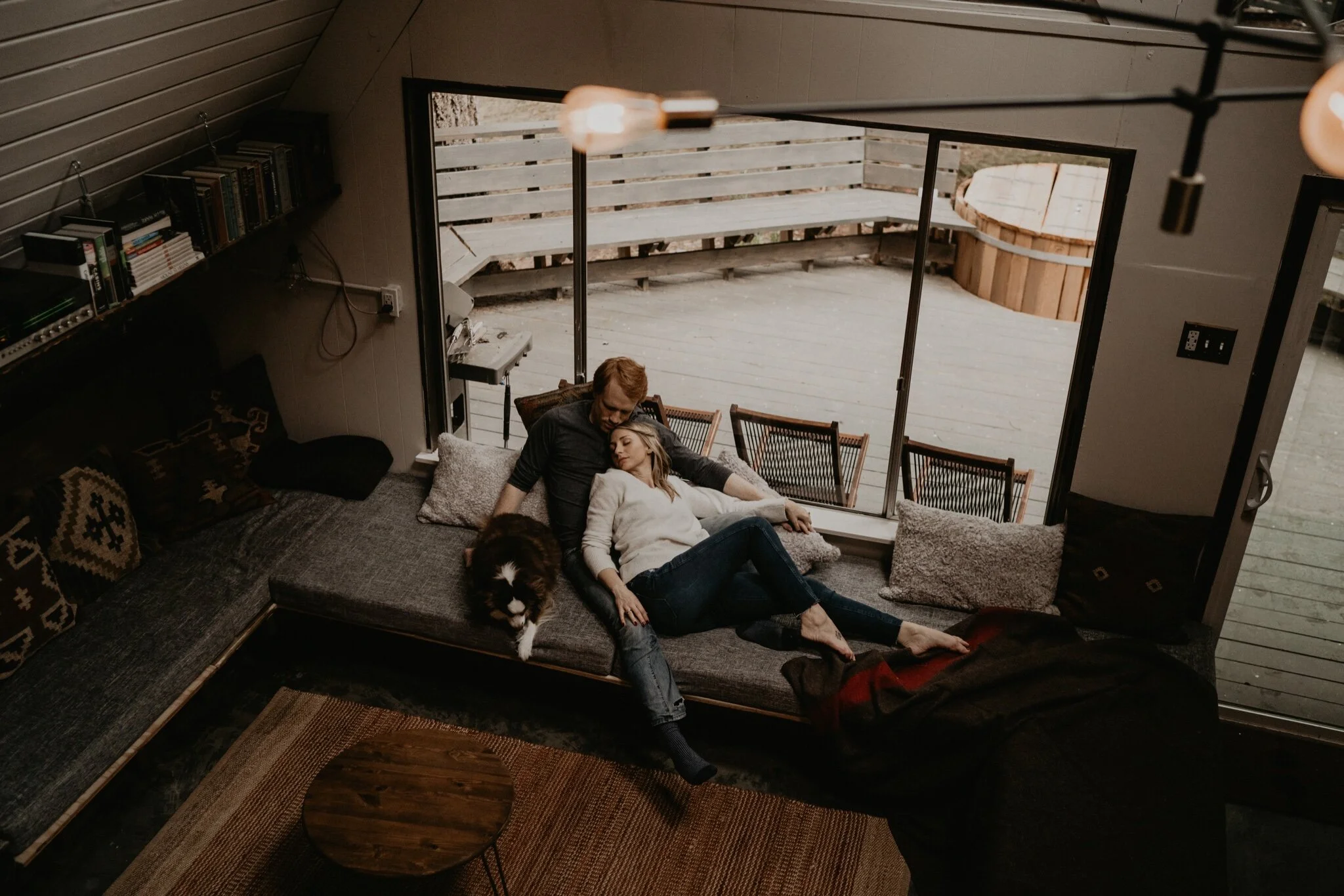Couple stay in a hot tub for their Intimate steamy in-home engagement session at an A-Frame Cabin in Mount Rainier National Park