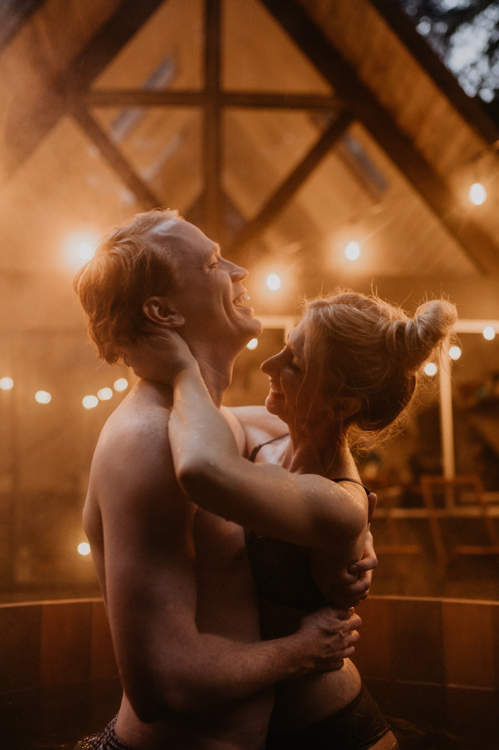Couple stay in a hot tub for their Intimate steamy in-home engagement session at an A-Frame Cabin in Mount Rainier National Park