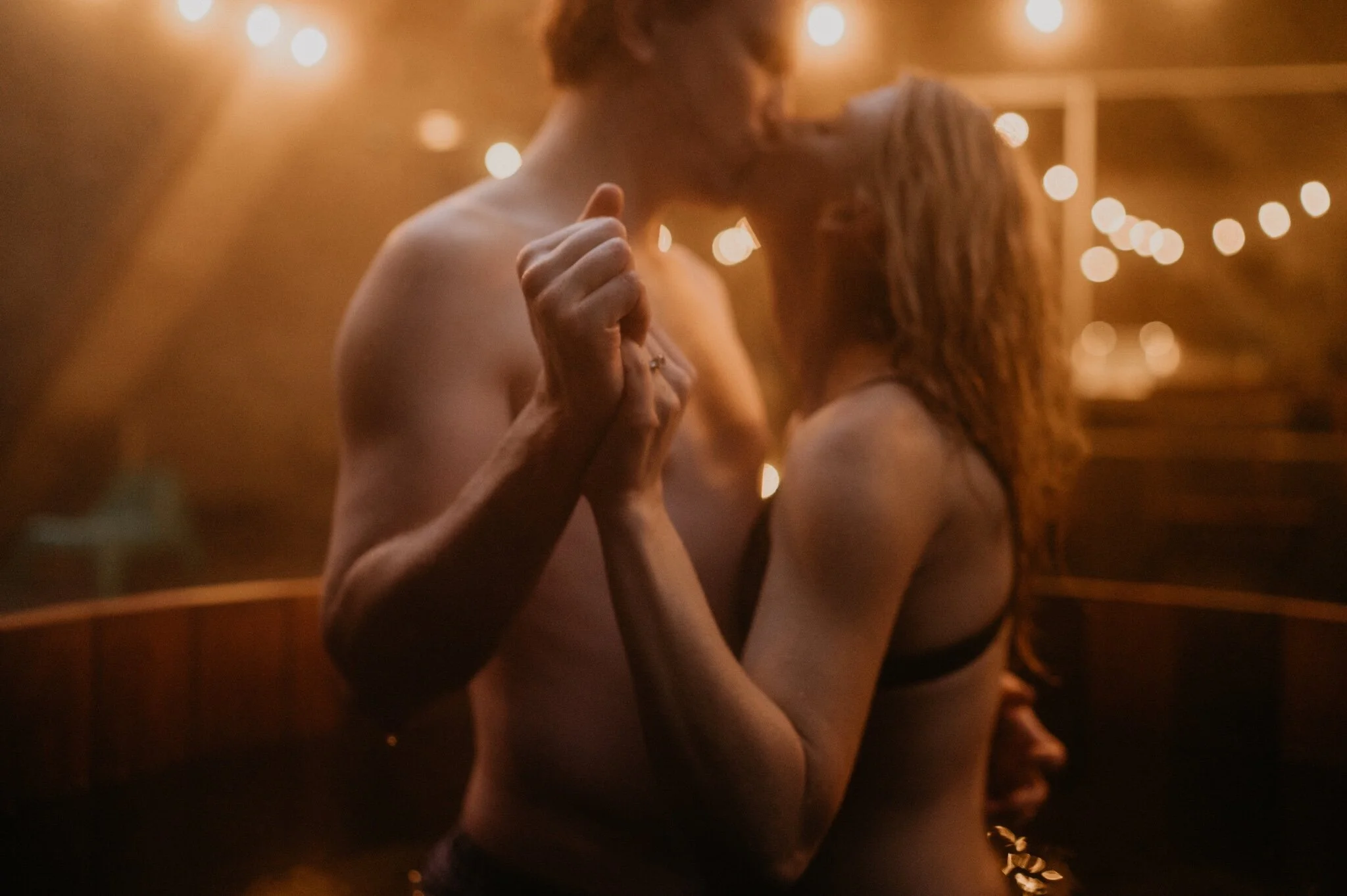 Couple stay in a hot tub for their Intimate steamy in-home engagement session at an A-Frame Cabin in Mount Rainier National Park