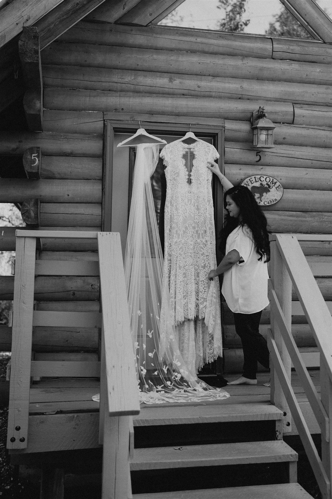 Alaska elopement bride grabbing wedding dress to get ready for elopement