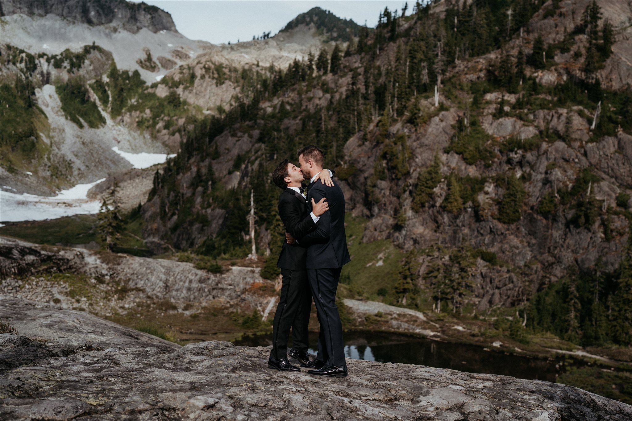 Two grooms kissing at their mountain elopement in the North Cascades