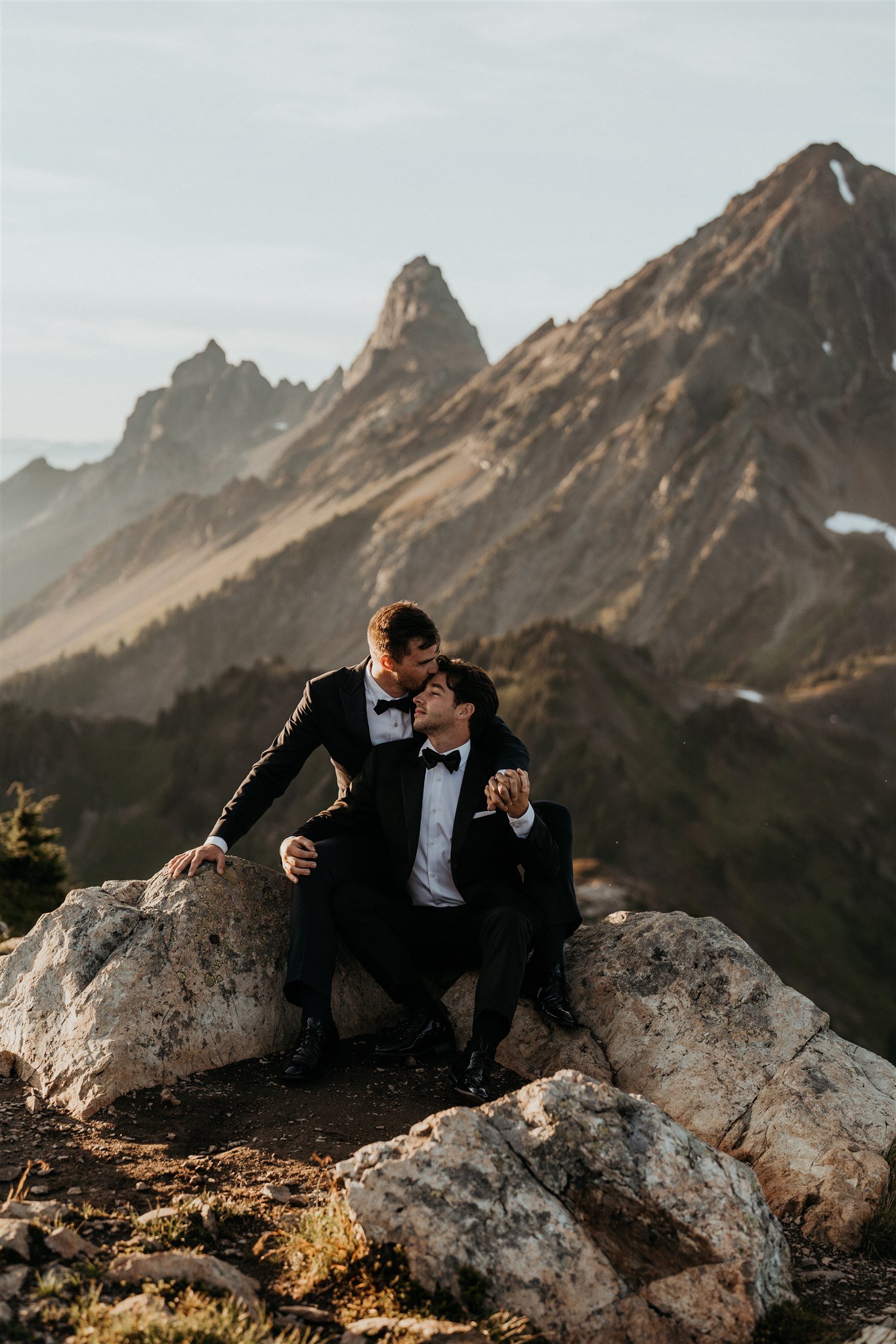 Two grooms sitting in the mountains in the North Cascades