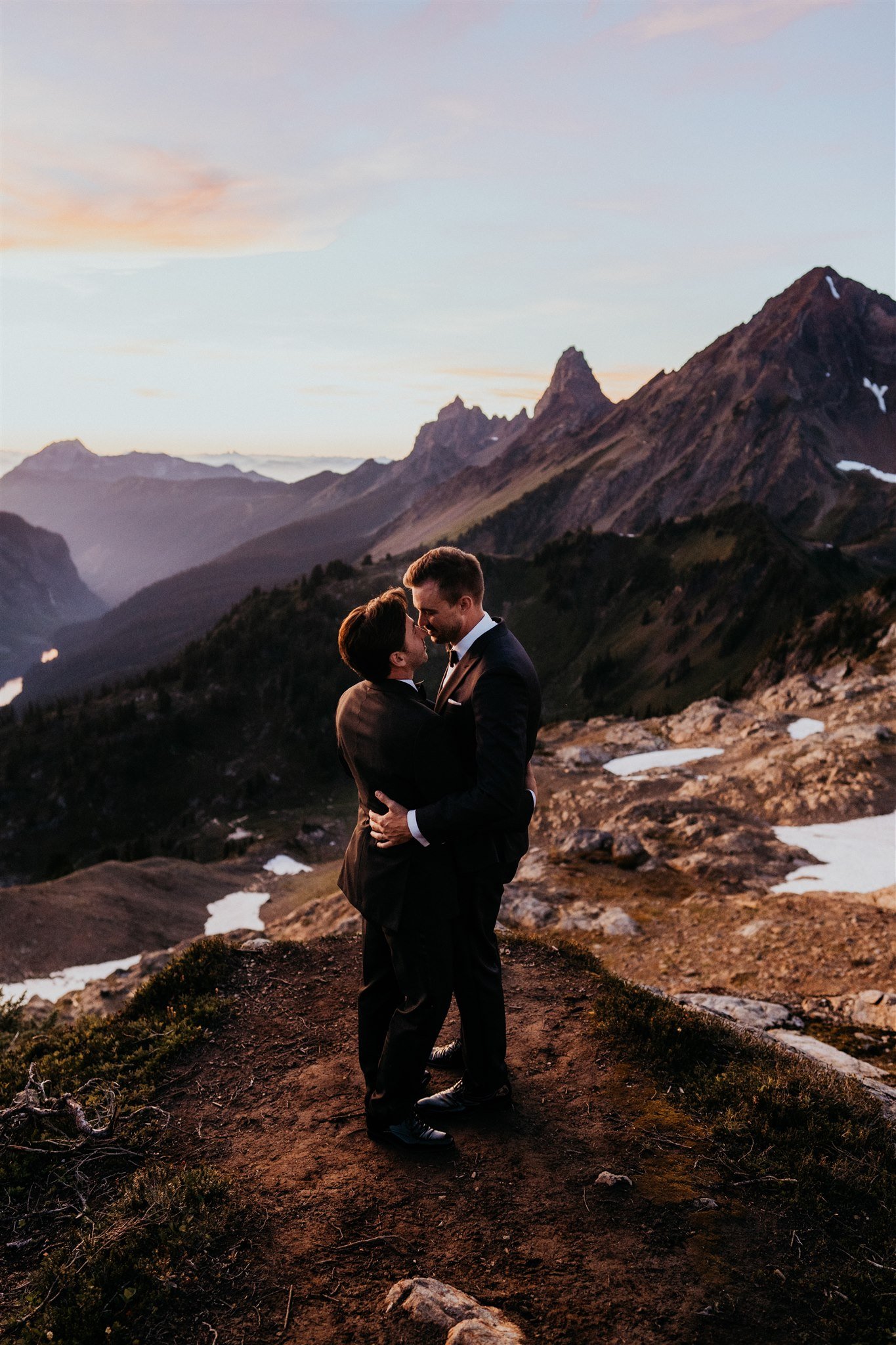 Two grooms kiss in the mountains for their North Cascades elopement