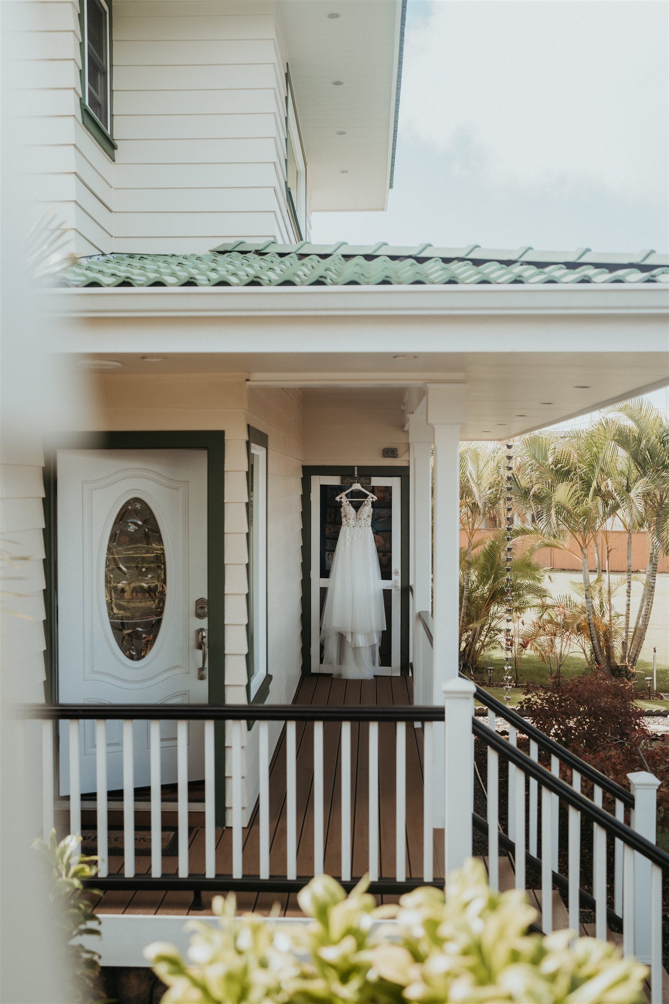 Wedding dress hanging on front door of house