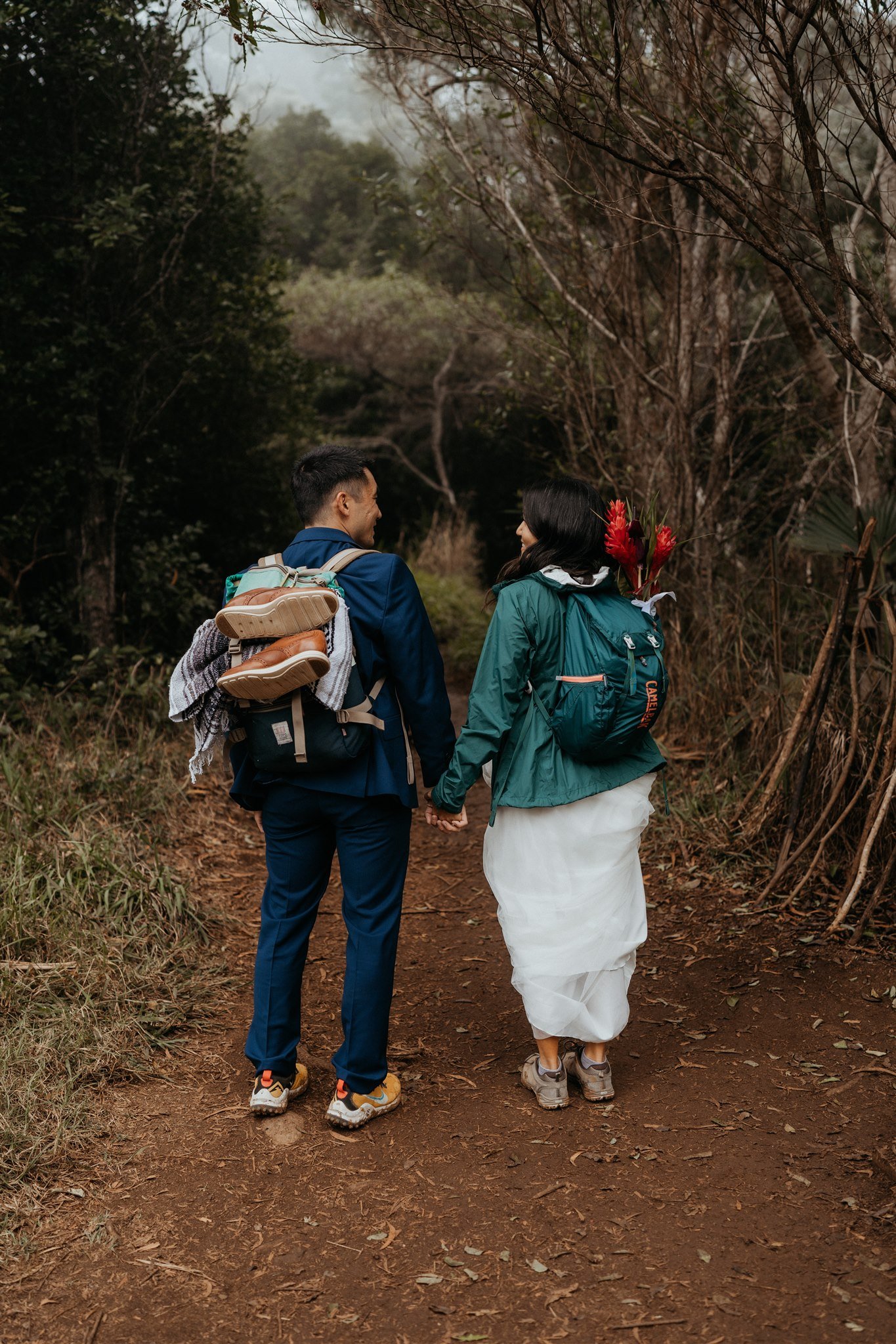 Bride and groom hiking a trail for their Kauai elopement