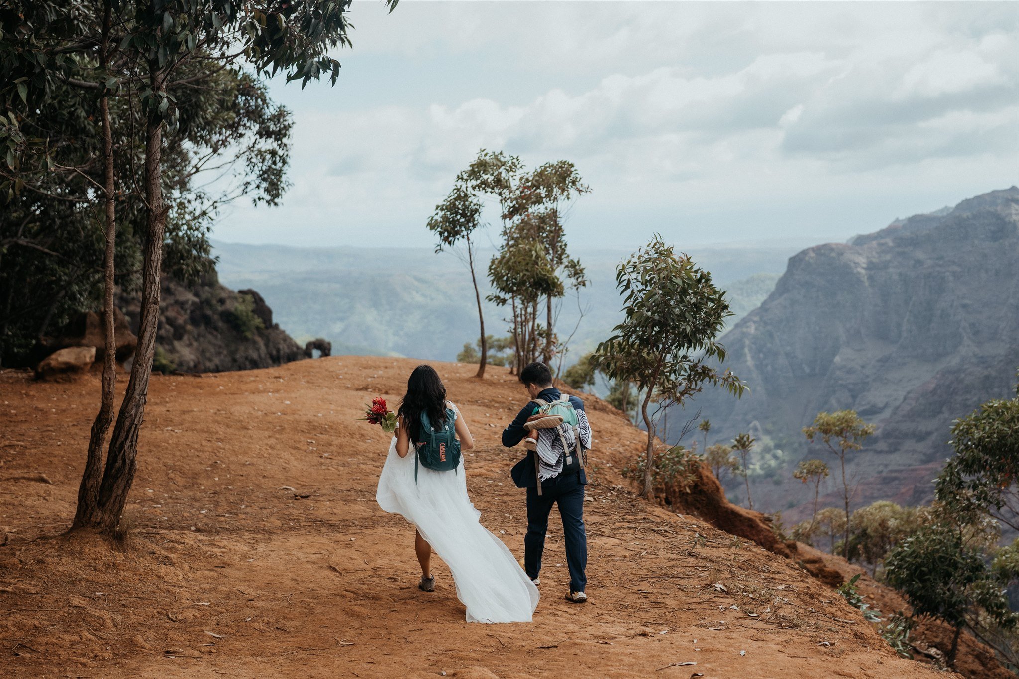Bride and groom walking to their ceremony spot for their Hawaii adventure elopement